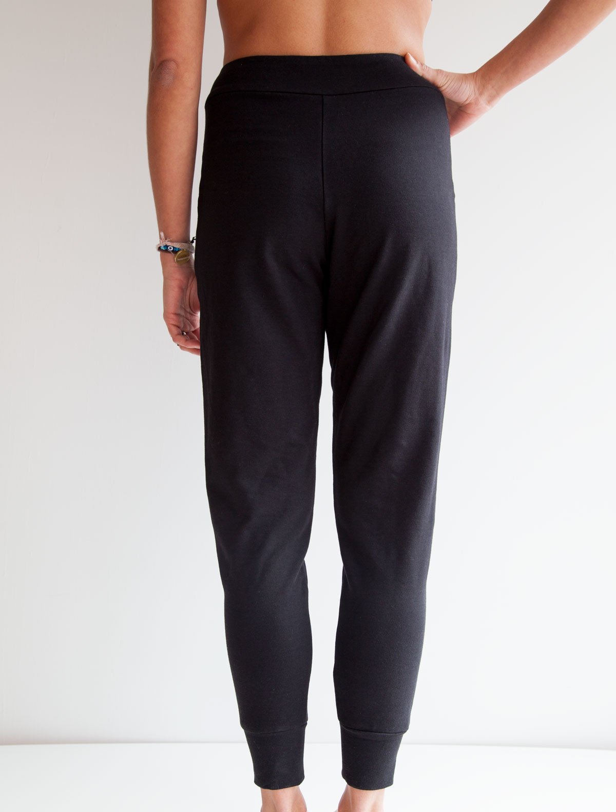 back view of model wearing simulacra's french terry trouser pants with pockets