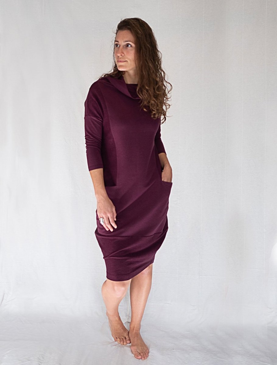 Front view of woman modeling the funnel neckline cocoon dress with pockets, in the color plum