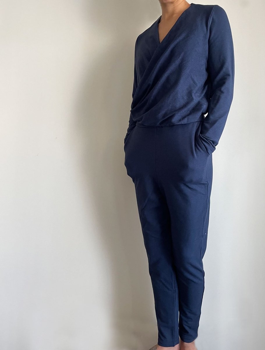 Left side view of model wearing simulacra's navy blue women's winter jumpsuit