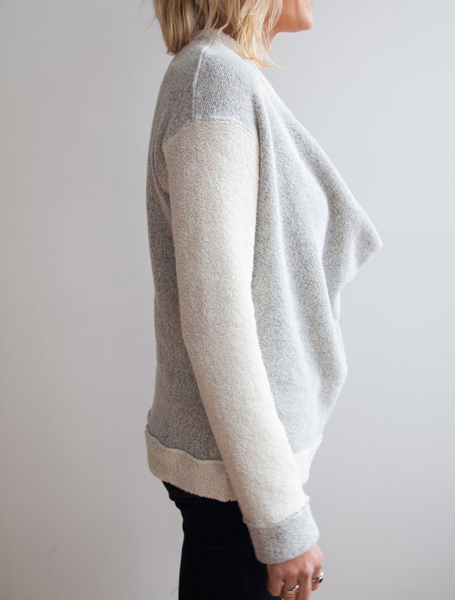 side view of model wearing the low drape neckline of Simulacra's 3-in-1 convertible sweater