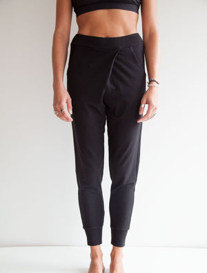 front view of model wearing simulacra's black french terry trouser pants with pockets