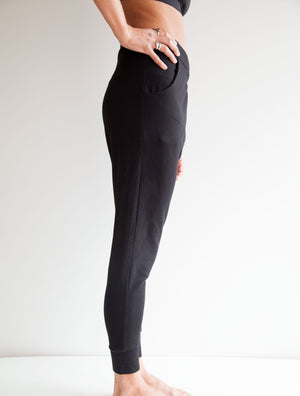 side view of model wearing simulacra's french terry trouser pants with pockets