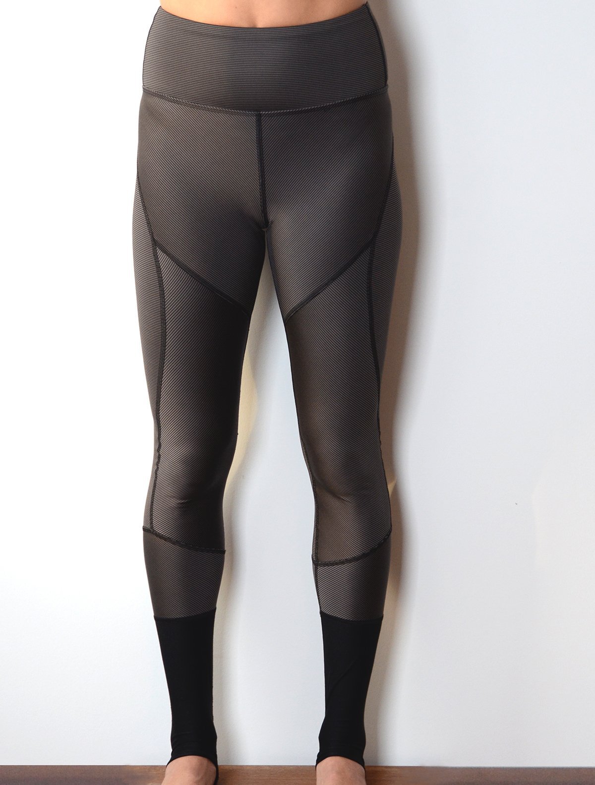 Front view of model wearing simulacra's women's full-length color block leggings in the grey/black stripe