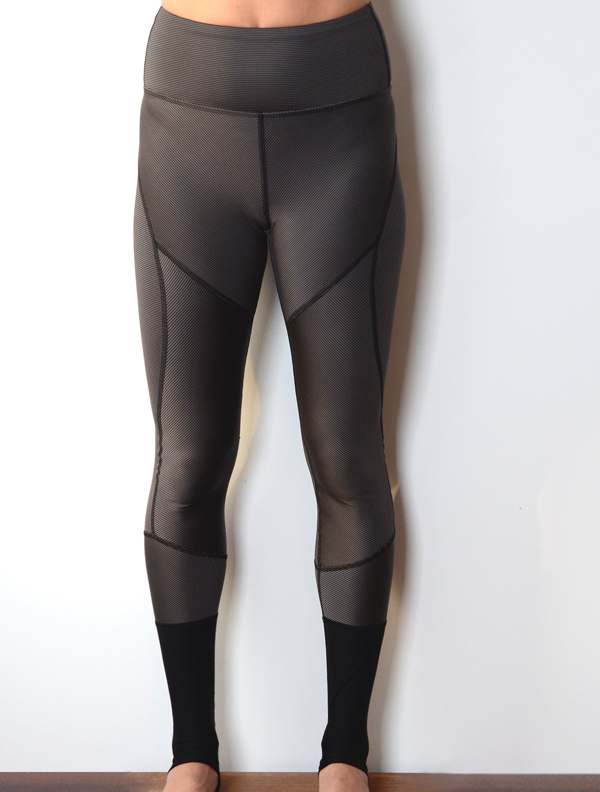 Front view of model wearing simulacra's women's full-length color block leggings in a grey stripe 