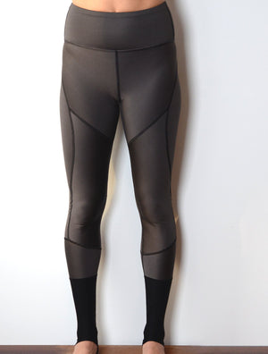 Front view of model wearing simulacra's women's full-length color block leggings in a grey stripe 