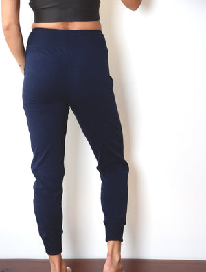 back view of model wearing simulacra's navy blue women' cropped joggers with pockets version 2.0 