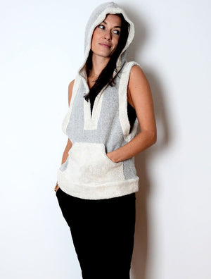 Front view of bemused smiling model wearing simulacra's woman's sleeveless hoodie