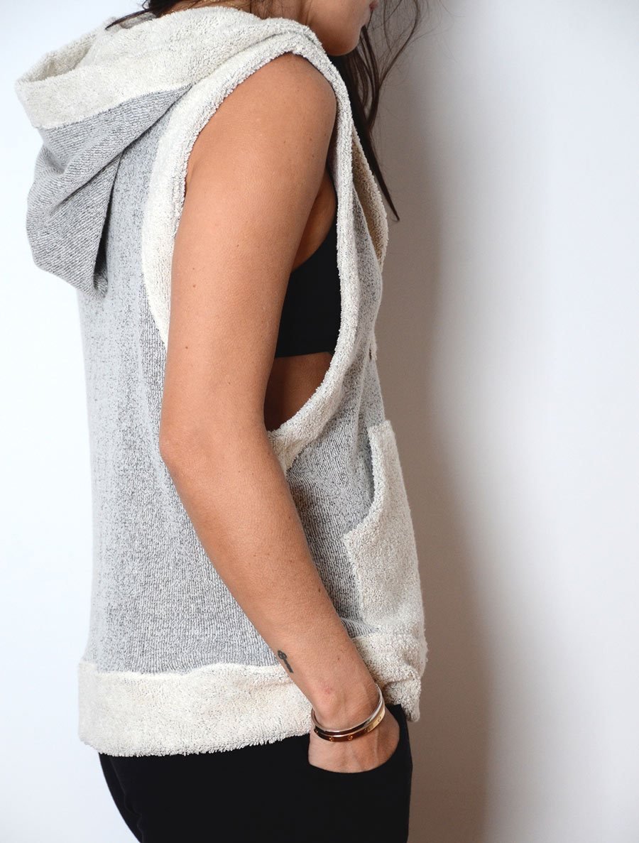 Right side view of  model wearing simulacra's woman's sleeveless hoodie