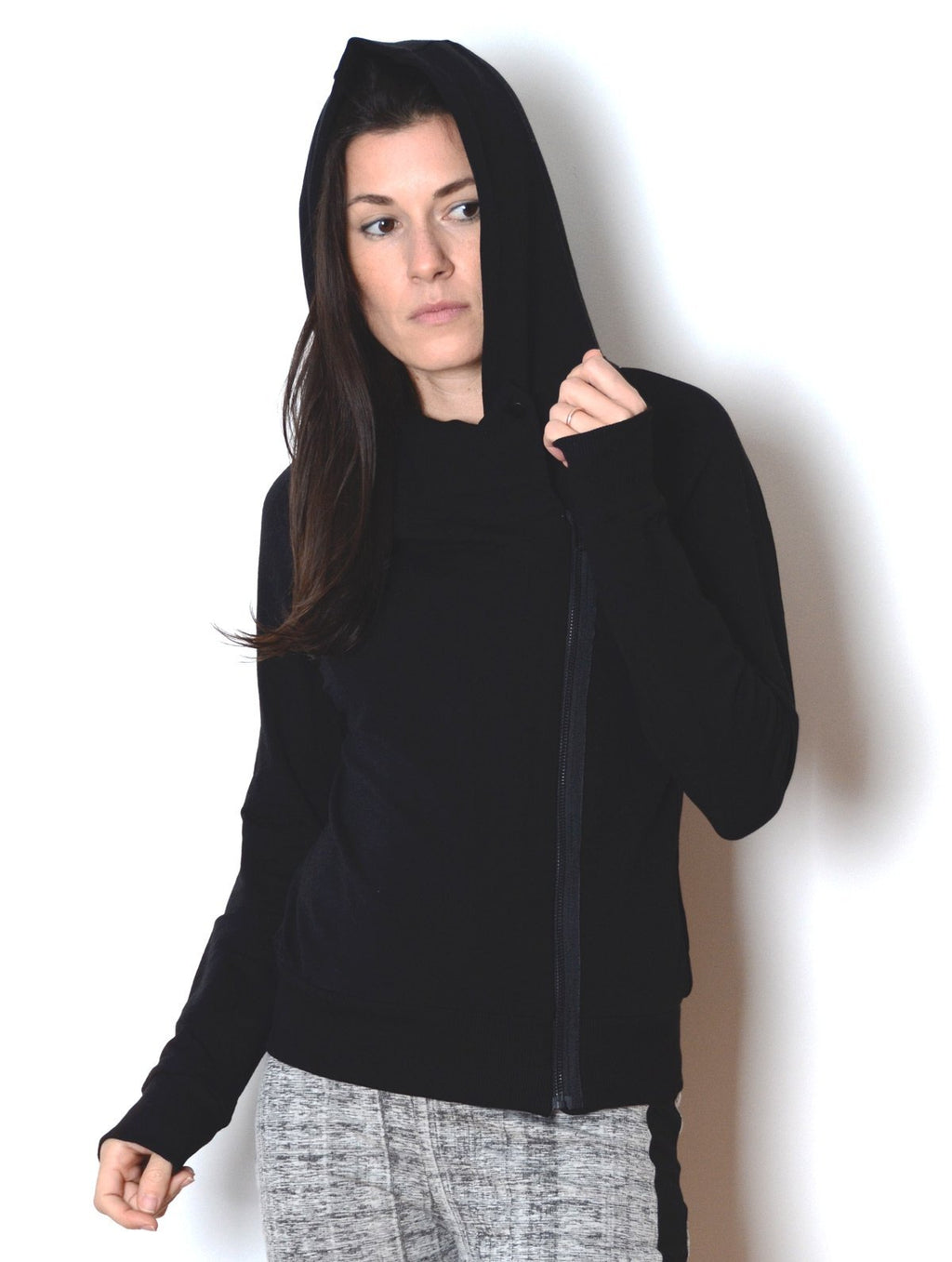 Front view of model wearing  simulacra's women's Black Cowl Neck Hoodie Sweater in a pose showing the assymetrical cut profile