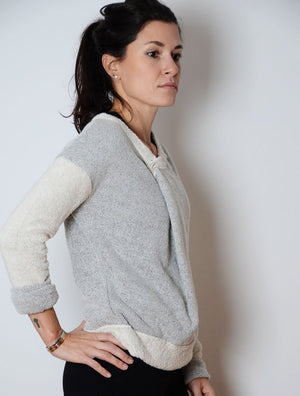 Model wearing simulacra's women's 3-in-1 convertible  sweater in a v neck