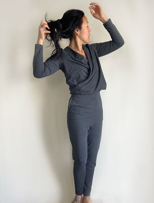 Front/side view of model wearing simulacra's charcoal grey women's winter jumpsuit