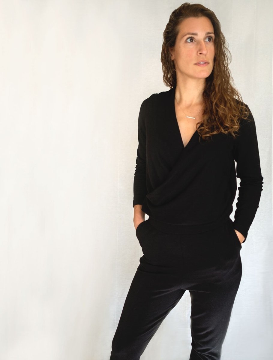 Left front view of model wearing simulacra's black winter jumpsuit