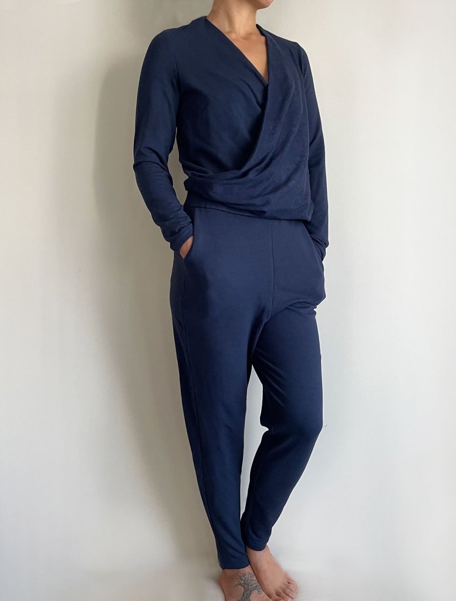Front/side view of model wearing simulacra's navy blue women's winter jumpsuit